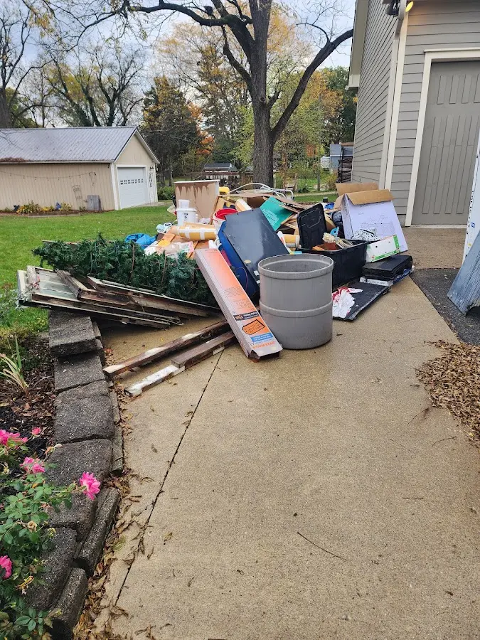 Dumpster being loaded with debris for 12 Yard Dumpster Rental in Gallatin
